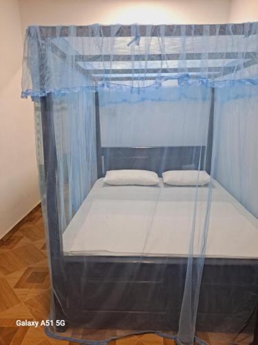 a bed in a canopy tent with two pillows at Sky Villa Weligama in Weligama