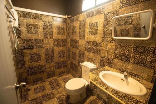 a bathroom with a toilet and a sink at BangPo Resort in Ban Bang Po