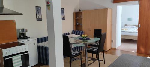 een keuken met een tafel en een kamer met een bed bij Apartmán Hluboká nad Vltavou in Hluboká nad Vltavou