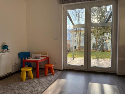 a room with a table and two chairs and a window at Wellness & Spa Apartments Lipno - Frymburk in Frymburk
