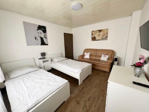 a small room with two beds and a couch at Cozy Workers Apartment in Siegburg in Siegburg