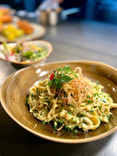 a plate of food with pasta on a table at Hotel-Restaurant Schwanen in Metzingen