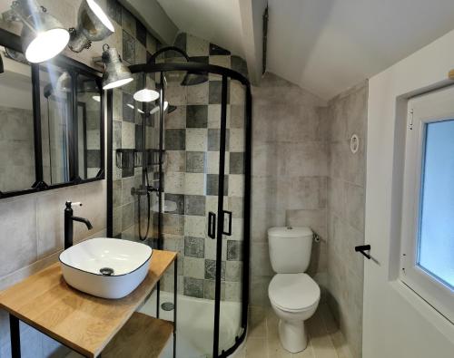 a bathroom with a toilet and a sink and a shower at Casetta in Ortiporio