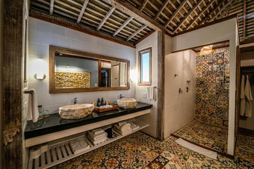 a bathroom with two sinks and a shower at Nayara Bocas del Toro in Bocas Town