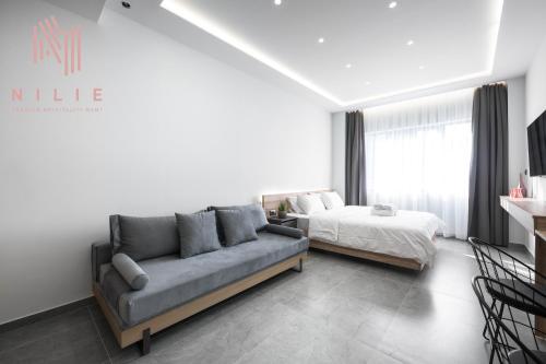 a living room with a couch and a bed at Pantheon, Nilie Hospitality MGMT in Thessaloniki