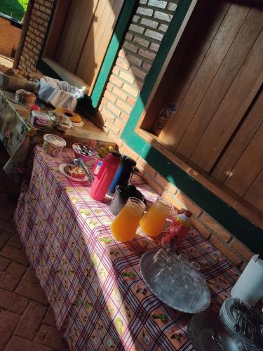 an overhead view of a table with two glasses of orange juice at Pousada do Chicó in São Roque de Minas