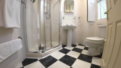 a bathroom with a shower and a toilet at The Old Manor House Hotel in Keynsham