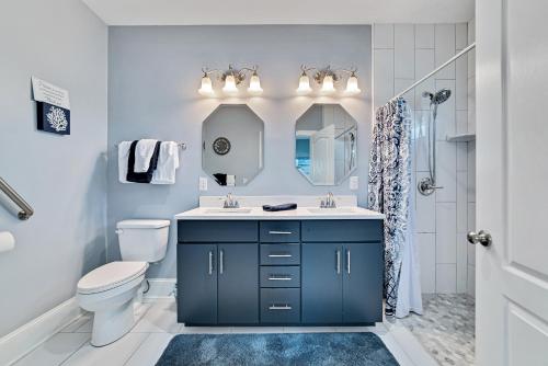 a bathroom with a sink and a toilet and a mirror at Ocean Overlook in Gulf Shores