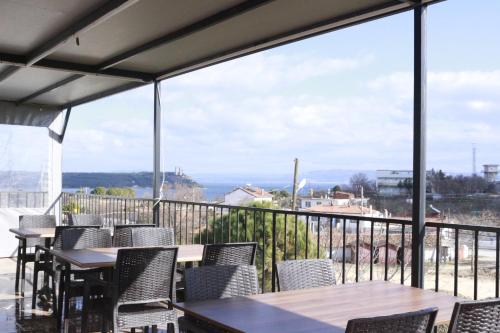 a view from the balcony of a restaurant with tables and chairs at Trekios Pansiyon & Cafe in Eceabat