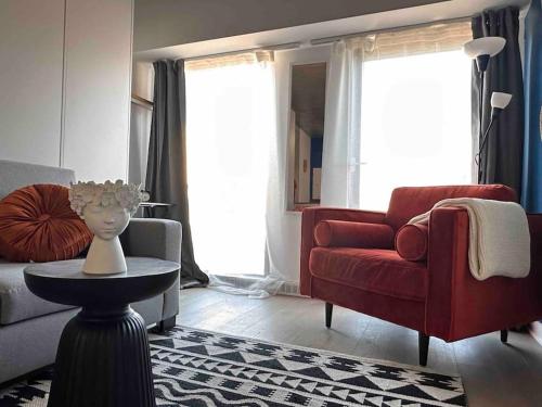 a living room with a red couch and a red chair at Downtown Montreal Premium Cozy Studio in Montréal