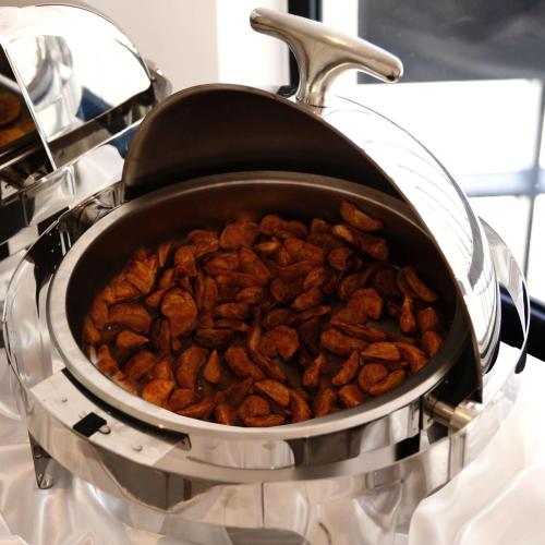 a pot full of nuts sitting on a stove at Sherao Hotel Doha - Next to National Museum of Qatar & Metro - فندق شراعوة الدوحة - بجانب متحف قطر الوطني ومحطة المترو in Doha