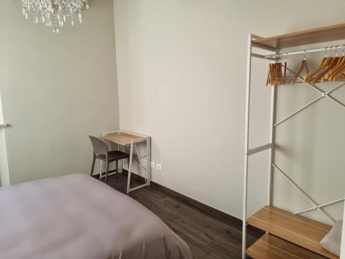 a bedroom with a bed and a desk and a chair at Casa Candio in Pavia