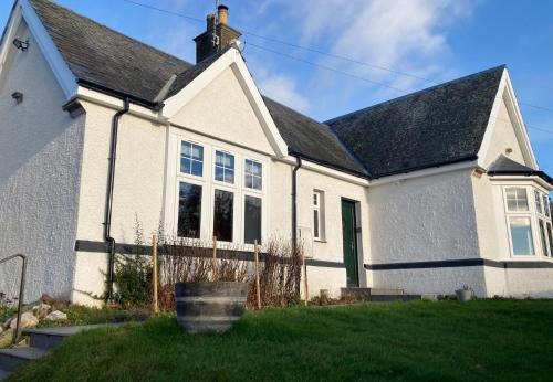 a white house with a black roof at Argaty Cottage in Doune