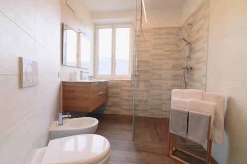 a bathroom with a toilet and a sink and a shower at B&B alla Villa in Giovo