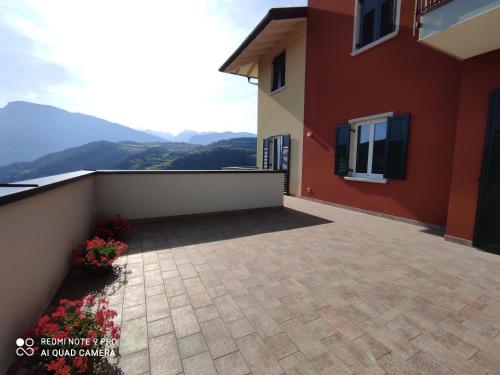 a balcony of a house with mountains in the background at B&B alla Villa in Giovo