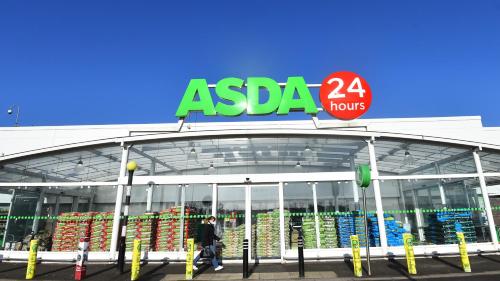 a man walking in front of a asda store at Private Modern Ensuite Room near Etihad Stadium in Manchester