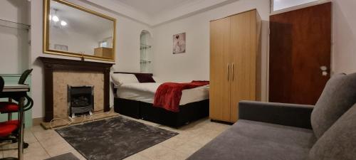 a bedroom with a bed with a fireplace and a chair at 4-Bed Apartment in Central London in London