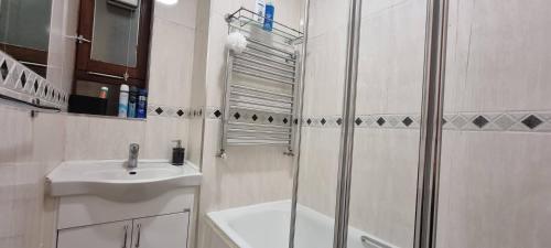 a bathroom with a shower and a sink at 4-Bed Apartment in Central London in London