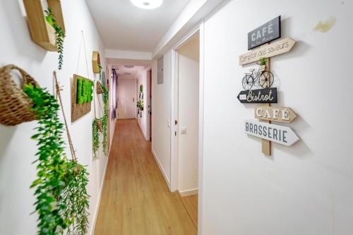 a hallway with signs on the wall at Apartamentos JAP Preciados in Madrid