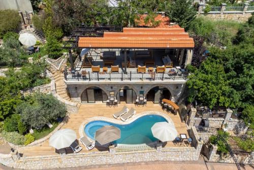 an aerial view of a house with a swimming pool at Authentic Villa with Pool and Garden in Beit Chabeb 