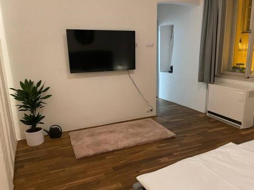 a living room with a flat screen tv on the wall at Prahabel - K10 in Prague