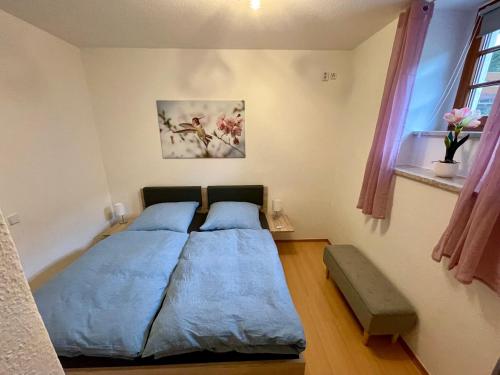 a bedroom with a bed with two pillows at Ferienwohnung Teichidyll Altenburg in Altenburg