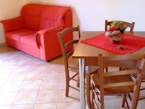 a living room with a table and a couch at Casale Vacanze in Siculiana