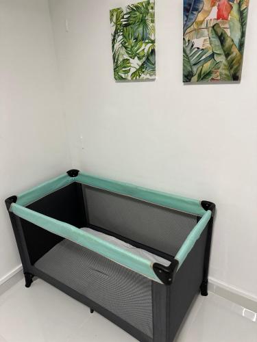 a black and green drawer with two pictures on the wall at CYRUS H-Housse cœur de ville in Pointe-à-Pitre