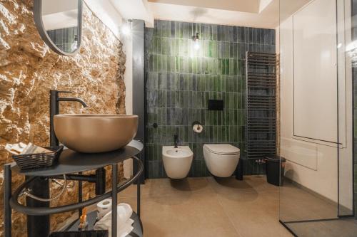 a bathroom with a sink and two toilets in it at Casa Cicetta in San Marino