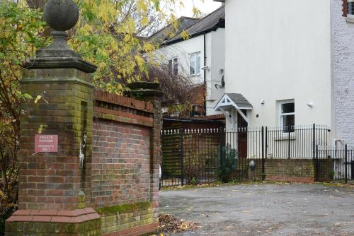 a brick fence in front of a house at The Old Brewery Boardroom - Winchester City Centre - Unique Property - Free Parking - Sleeps 6 - by XPlus Stays in Winchester