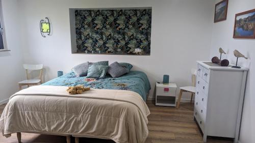 Un dormitorio con una cama con un osito de peluche. en Domaine de la Griffe - Chambres d'hôtes à la montagne, en La Roche-sur-Foron