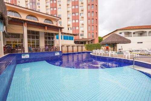 a large blue swimming pool in a building at HOT SPRINGS HOTEL - BVTUR in Caldas Novas