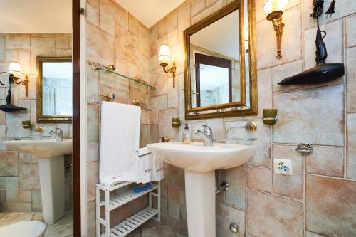 a bathroom with two sinks and a mirror at Supercrans, Rte de la Tour 10, Superb View!! in Crans-Montana