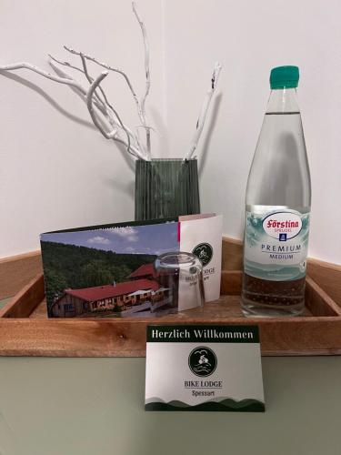 a bottle of water and a box and a candle at Bike Lodge Spessart in Lohr