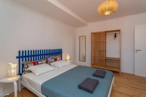a bedroom with a large blue bed in a room at Mouraria Lisbon Soul Apartments T1 - 4 pax in Lisbon