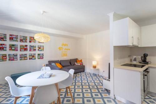 a living room with a white table and a couch at Mouraria Lisbon Soul Apartments T1 - 4 pax in Lisbon