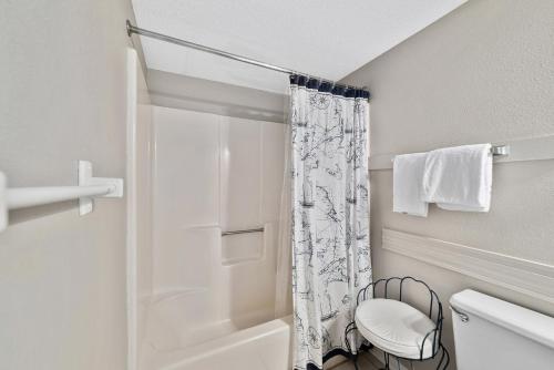a bathroom with a shower curtain and a toilet at Phoenix 1093 in Orange Beach