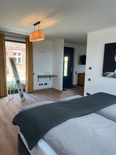 a bedroom with a large bed and a desk at Ferien auf dem Land bei Neuruppin in Lichtenberg