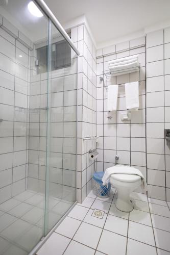 a bathroom with a toilet and a glass shower at DiRoma Exclusive - HUP CALDAS NOVAS in Caldas Novas