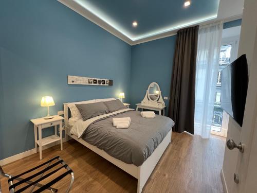 a blue bedroom with a bed and a chair at Casa Imperatore in Naples