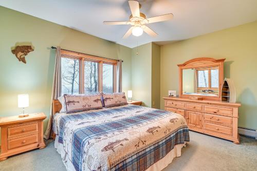 a bedroom with a bed and a ceiling fan at Secluded Adirondack Cabin about 5 Mi to Sacandaga Lake in Broadalbin
