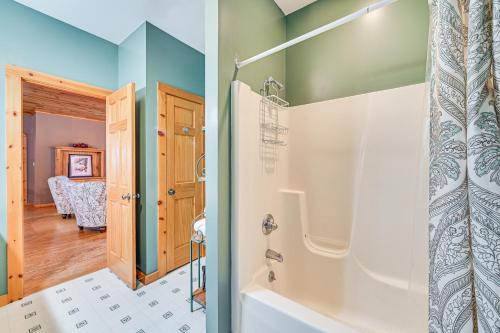 a bathroom with a shower and a tub at Secluded Adirondack Cabin about 5 Mi to Sacandaga Lake in Broadalbin