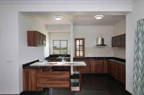 a kitchen with a island in the middle of it at ZIONS AIRPORT HOTEL in Bangalore