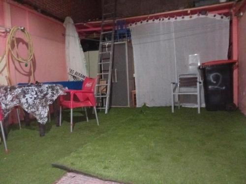 a tent with a table and chairs and a ladder at de paso Alcobendas in Alcobendas