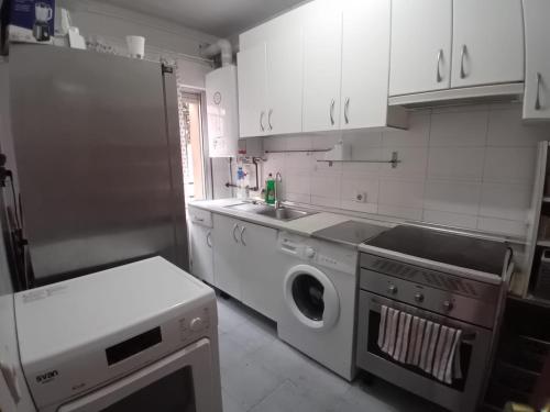 a kitchen with a washer and a sink and a dishwasher at de paso Alcobendas in Alcobendas