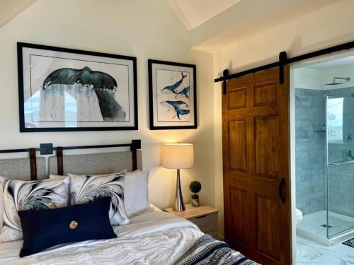 a bedroom with a bed and a glass shower at Bambury's Hillside Chalets in Rocky Harbour