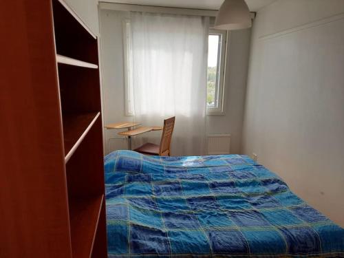 a bedroom with a bed and a desk and a window at 50m2 Apartment FREE Parking and Laundry, 20min to Center in Espoo