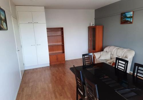 a living room with a table and a couch at 50m2 Apartment FREE Parking and Laundry, 20min to Center in Espoo