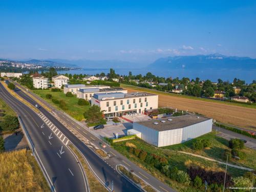 an overhead view of a building next to a highway at Starling Hotel Lausanne in Lausanne