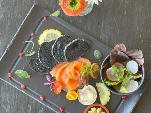 a tray of food with seafood and vegetables on it at Starling Hotel Lausanne in Lausanne